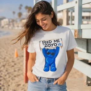 Woman wearing the white Feed Me ZOYO Buddy Tee at the beach
