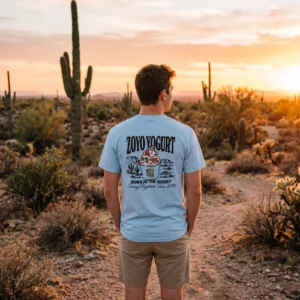 Man wearing the light blue ZOYO x State 48 T-Shirt among saguaros at sunset